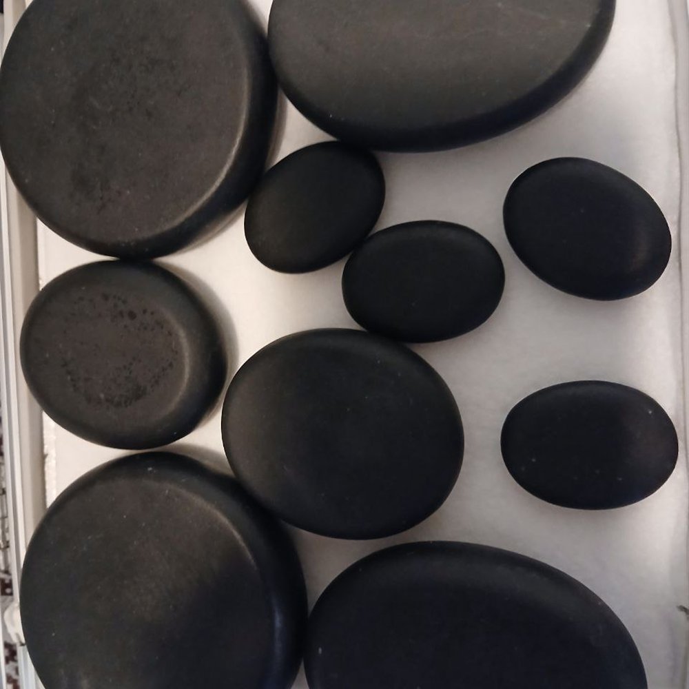 Hot stones prepared for massage therapy